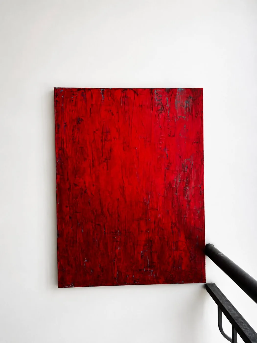 Crimson Dawn, a red textured painting on a white stairwell wall